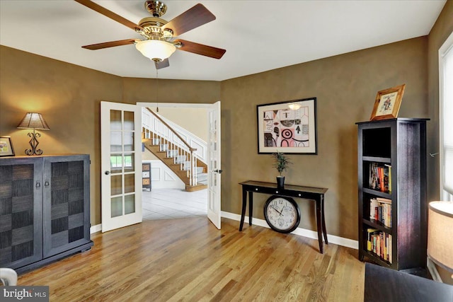 17 N Carolina Ave, Reading, PA 19608 - living area with stairs, wood finished floors, a ceiling fan, and baseboards