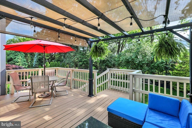 17 N Carolina Ave, Reading, PA 19608 - wooden deck with outdoor dining area, a pergola, and view of wooded area