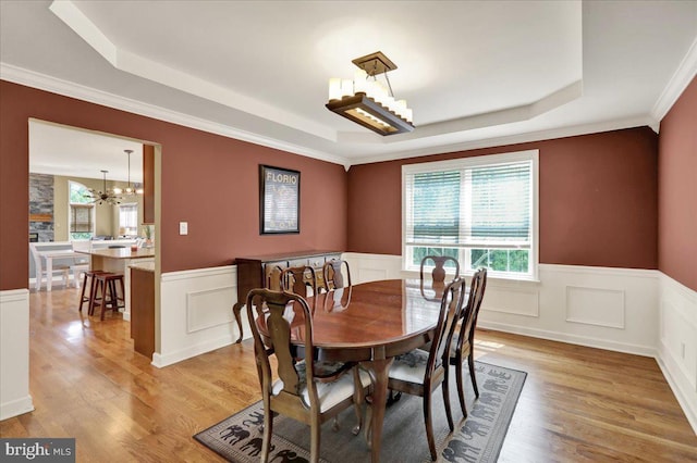 17 N Carolina Ave, Reading, PA 19608 - dining space featuring a tray ceiling, a chandelier, a wainscoted wall, light wood-style flooring, and ornamental molding