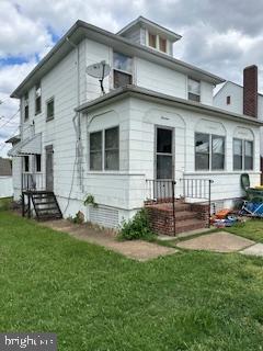 14 3rd Ave, Baltimore, MD 21225 - back of property featuring a lawn and a chimney