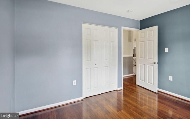 6715 Valley Park Rd, Capitol Heights, MD 20743 - unfurnished bedroom with a closet, wood finished floors, and baseboards