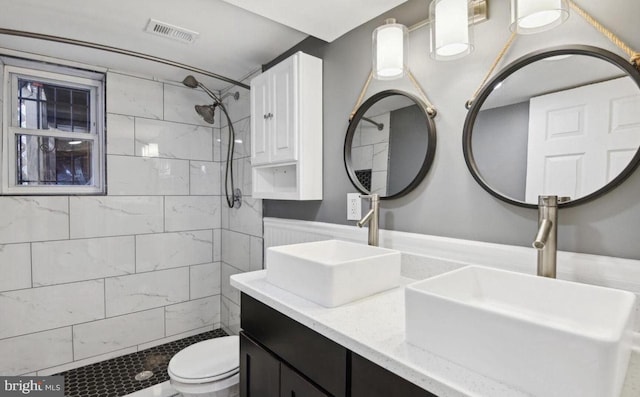 6715 Valley Park Rd, Capitol Heights, MD 20743 - full bathroom featuring toilet, tiled shower, and double vanity