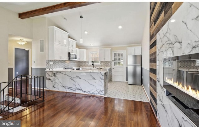 6715 Valley Park Rd, Capitol Heights, MD 20743 - kitchen featuring appliances with stainless steel finishes, tasteful backsplash, dark wood finished floors, a peninsula, and recessed lighting