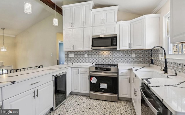 6715 Valley Park Rd, Capitol Heights, MD 20743 - kitchen featuring appliances with stainless steel finishes, wine cooler, a sink, and white cabinetry