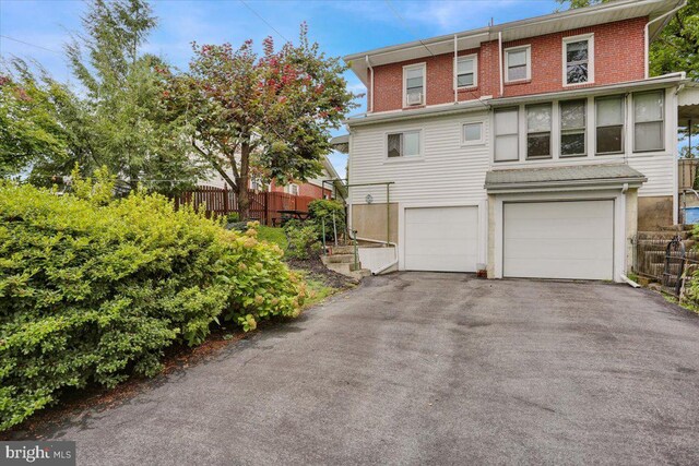 1322 Brooke Blvd, Reading, PA 19607 - back of property with a garage and asphalt driveway