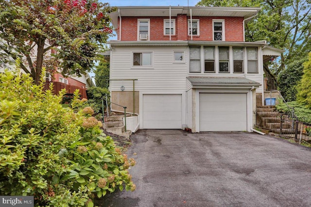 1322 Brooke Blvd, Reading, PA 19607 - view of front of house featuring asphalt driveway, an attached garage, and brick siding
