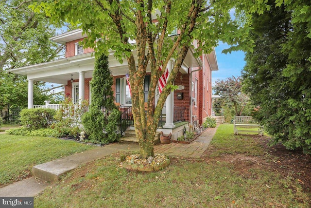 1322 Brooke Blvd, Reading, PA 19607 - traditional style home with brick siding, covered porch, and a front yard