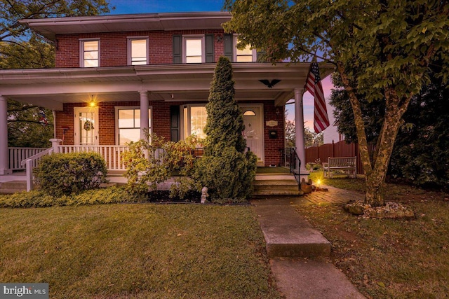 1322 Brooke Blvd, Reading, PA 19607 - view of front of home featuring brick siding, covered porch, and a lawn