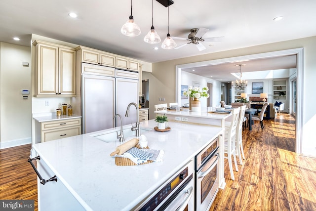 6153 Long Point Rd, Neavitt, MD 21652 - kitchen with cream cabinets, a sink, wood finished floors, open floor plan, and a ceiling fan