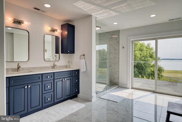 6153 Long Point Rd, Neavitt, MD 21652 - full bathroom with marble tiled floors, walk in shower, double vanity, baseboards, and recessed lighting