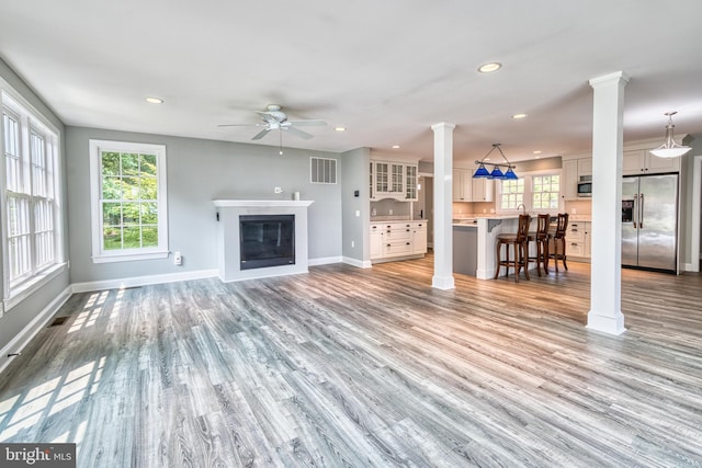6153 Long Point Rd, Neavitt, MD 21652 - unfurnished living room featuring ornate columns, ceiling fan, baseboards, light wood-style flooring, and recessed lighting