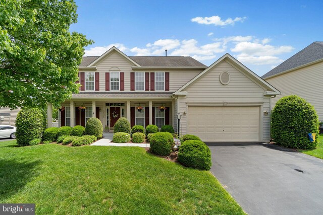 5631 Jordan Blvd, New Market, MD 21774 - colonial-style house with asphalt driveway, a front yard, an attached garage, and covered porch