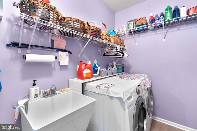5631 Jordan Blvd, New Market, MD 21774 - laundry room featuring washer and clothes dryer, wood finished floors, and baseboards
