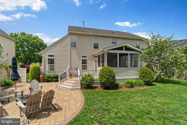 5631 Jordan Blvd, New Market, MD 21774 - rear view of house featuring a sunroom, a patio, a yard, and a wooden deck