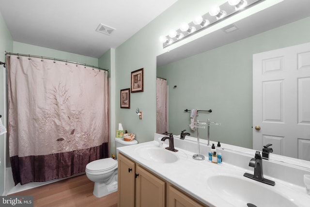 5631 Jordan Blvd, New Market, MD 21774 - bathroom featuring double vanity, toilet, wood finished floors, and shower / bath combo
