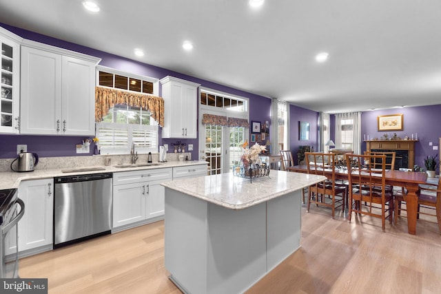 5631 Jordan Blvd, New Market, MD 21774 - kitchen featuring dishwasher, a sink, light wood-type flooring, white cabinetry, and a center island