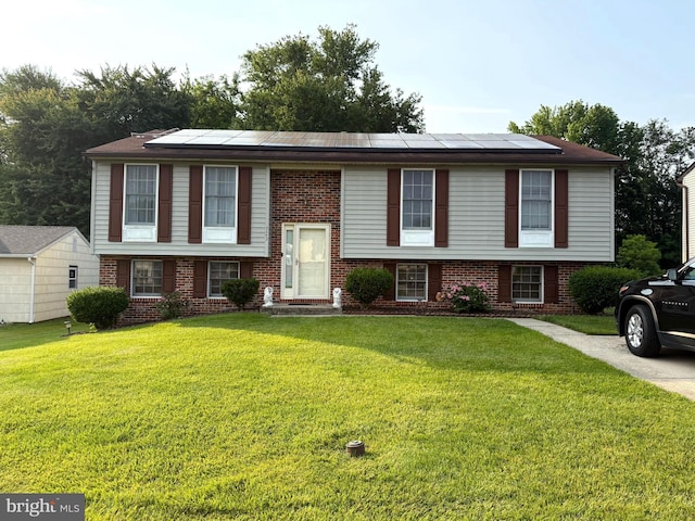 723 Walker St, Aberdeen, MD 21001 - bi-level home with brick siding, solar panels, and a front yard