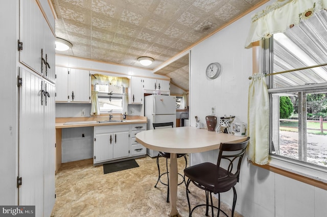 2942 Oley Turnpike Rd, Reading, PA 19606 - kitchen featuring freestanding refrigerator, an ornate ceiling, a sink, light countertops, and white cabinets