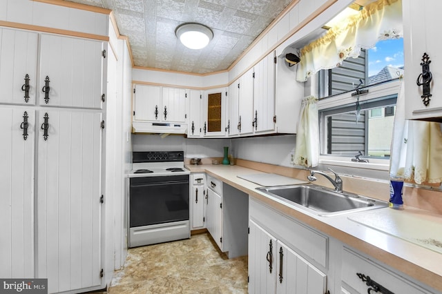 2942 Oley Turnpike Rd, Reading, PA 19606 - kitchen with range with electric stovetop, under cabinet range hood, a sink, light countertops, and white cabinetry