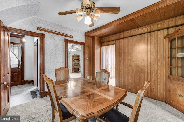 2942 Oley Turnpike Rd, Reading, PA 19606 - dining area with ceiling fan, light colored carpet, wood walls, and baseboards