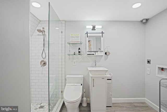 1413 Hopkins St NW, Washington, DC 20036 - full bathroom featuring tiled shower, vanity, toilet, baseboards, and wood finished floors