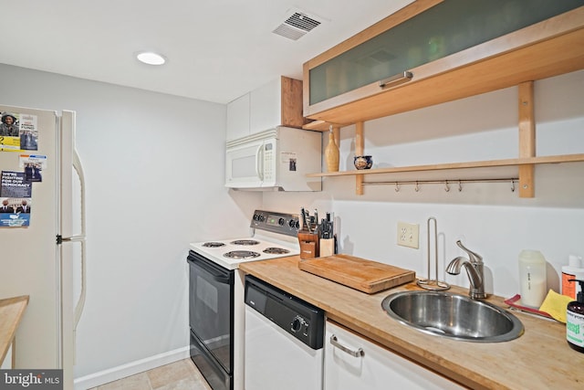 1413 Hopkins St NW, Washington, DC 20036 - kitchen featuring white appliances, a sink, white cabinetry, open shelves, and baseboards