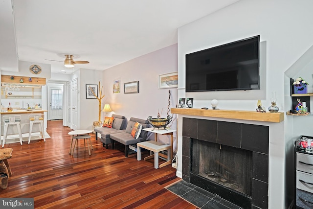 1413 Hopkins St NW, Washington, DC 20036 - living room with wood finished floors, ceiling fan, and a tiled fireplace