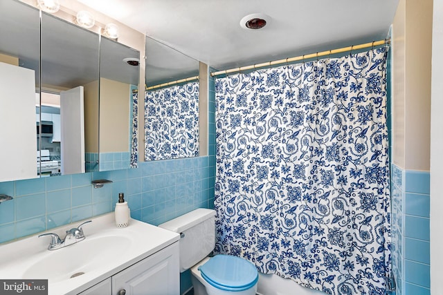 2939 Van Ness St NW Unit 1144, Washington, DC 20008 - bathroom with tile walls, toilet, vanity, and curtained shower