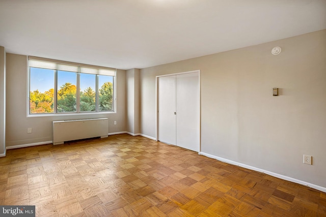 2939 Van Ness St NW Unit 1144, Washington, DC 20008 - unfurnished bedroom featuring radiator, baseboards, and a closet