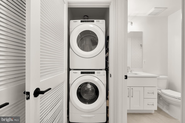 4335 Harrison St NW Unit 2, Washington, DC 20015 - laundry room with stacked washer / drying machine and light tile patterned flooring