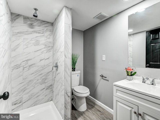 3812 Midheights Rd, Baltimore, MD 21215 - bathroom with vanity, toilet, tiled shower, and wood finished floors