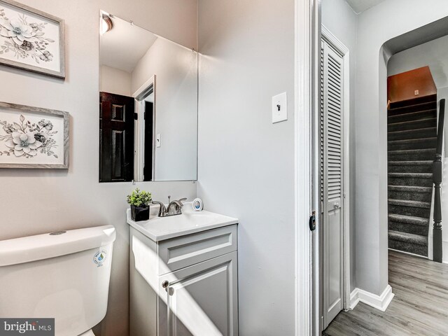 3812 Midheights Rd, Baltimore, MD 21215 - bathroom featuring vanity, toilet, wood finished floors, and baseboards