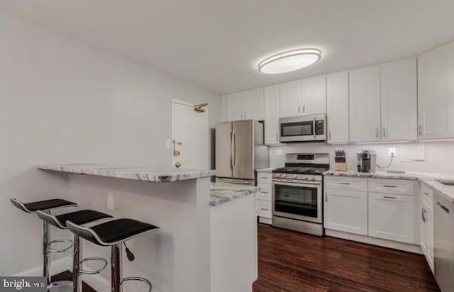 1300 Army Navy Dr Unit 803, Arlington, VA 22202 - kitchen featuring appliances with stainless steel finishes, a breakfast bar area, and white cabinets