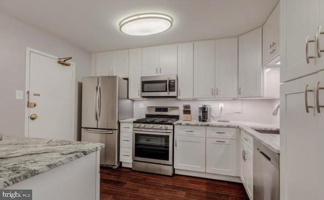 1300 Army Navy Dr Unit 803, Arlington, VA 22202 - kitchen with stainless steel appliances, dark wood-style flooring, white cabinets, and light stone countertops