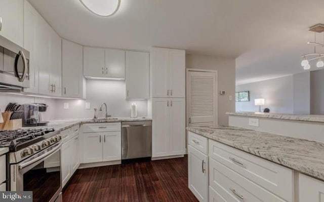 1300 Army Navy Dr Unit 803, Arlington, VA 22202 - kitchen featuring stainless steel appliances, white cabinets, dark wood-style floors, light stone countertops, and a sink