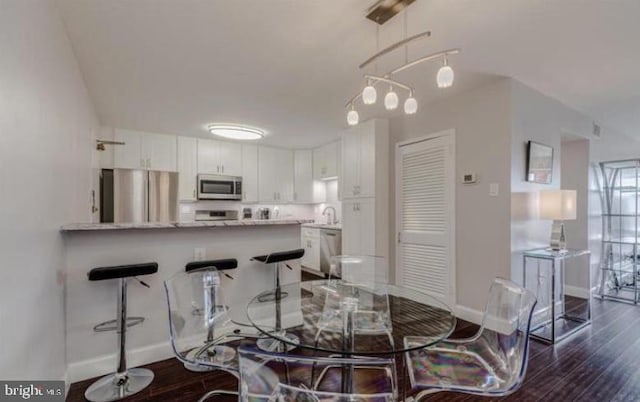 1300 Army Navy Dr Unit 803, Arlington, VA 22202 - dining space featuring baseboards and dark wood-style flooring