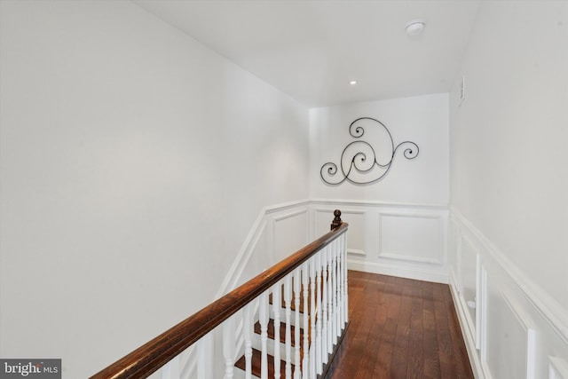 1537 S 2nd St, Philadelphia, PA 19147 - hallway with dark wood finished floors, wainscoting, a decorative wall, and an upstairs landing