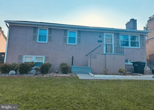 1709 Reaves St, Winchester, VA 22601 - view of front of property featuring a front yard, brick siding, and a chimney