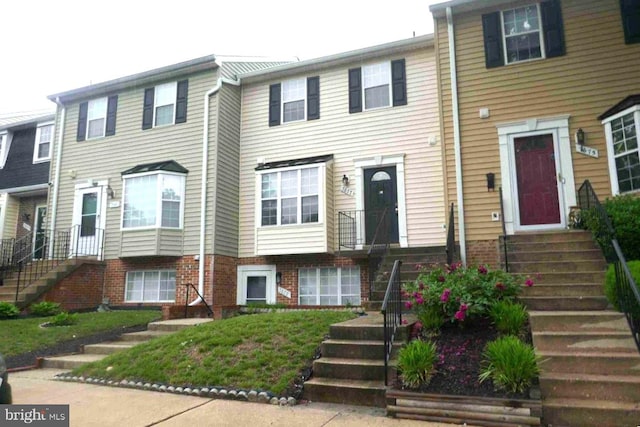 7677 E Arbory Ct Unit 231, Laurel, MD 20707 - townhome / multi-family property featuring stairway and brick siding