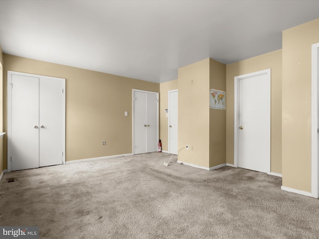 7677 E Arbory Ct Unit 231, Laurel, MD 20707 - unfurnished bedroom featuring two closets, baseboards, and carpet floors