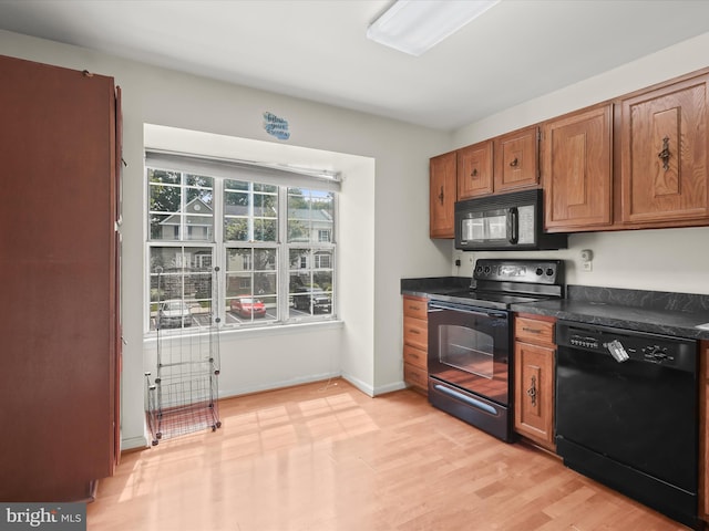 7677 E Arbory Ct Unit 231, Laurel, MD 20707 - kitchen featuring black appliances, dark countertops, brown cabinetry, light wood-style floors, and baseboards