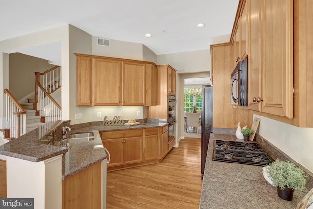 1650 Colonial Hills Dr, Mclean, VA 22102 - kitchen featuring black gas cooktop, a peninsula, light wood-type flooring, dark stone counters, and recessed lighting