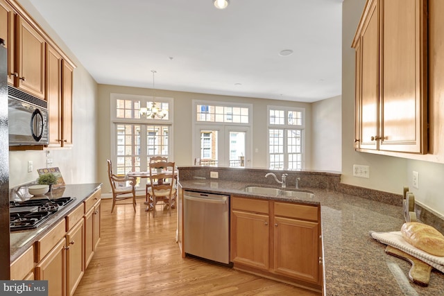 1650 Colonial Hills Dr, Mclean, VA 22102 - kitchen featuring stainless steel appliances, light wood finished floors, a peninsula, dark stone counters, and a chandelier