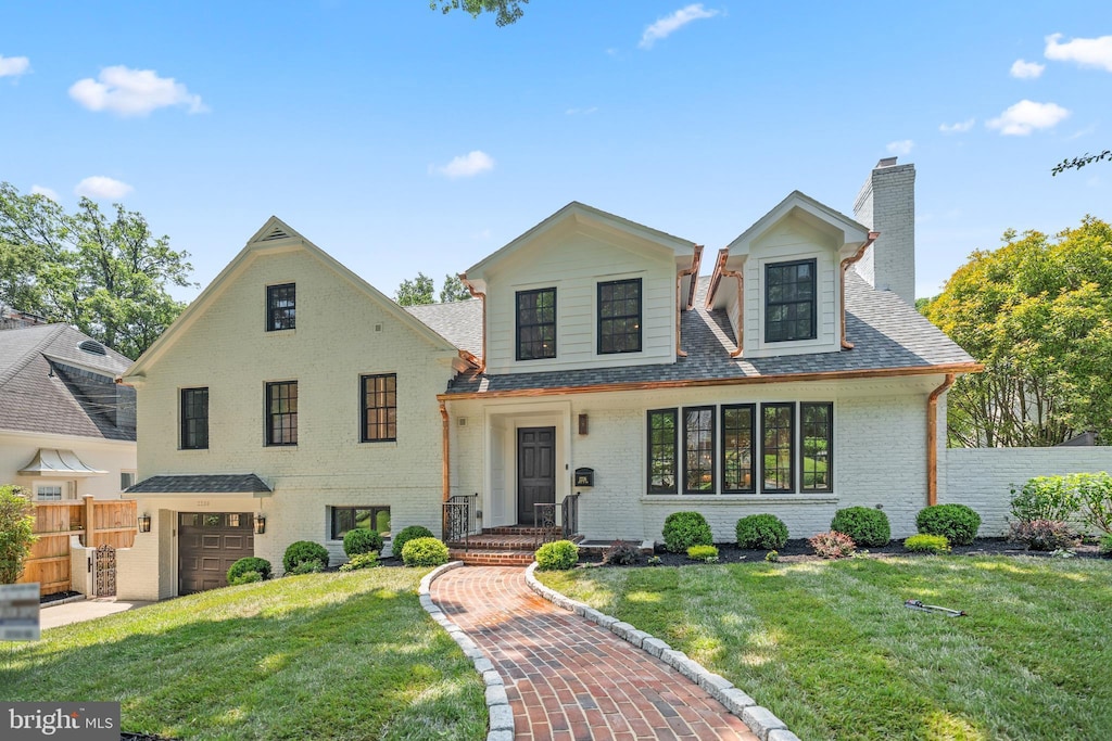 2236 46th St NW, Washington, DC 20007 - view of front of home with a chimney, a garage, brick siding, and a shingled roof