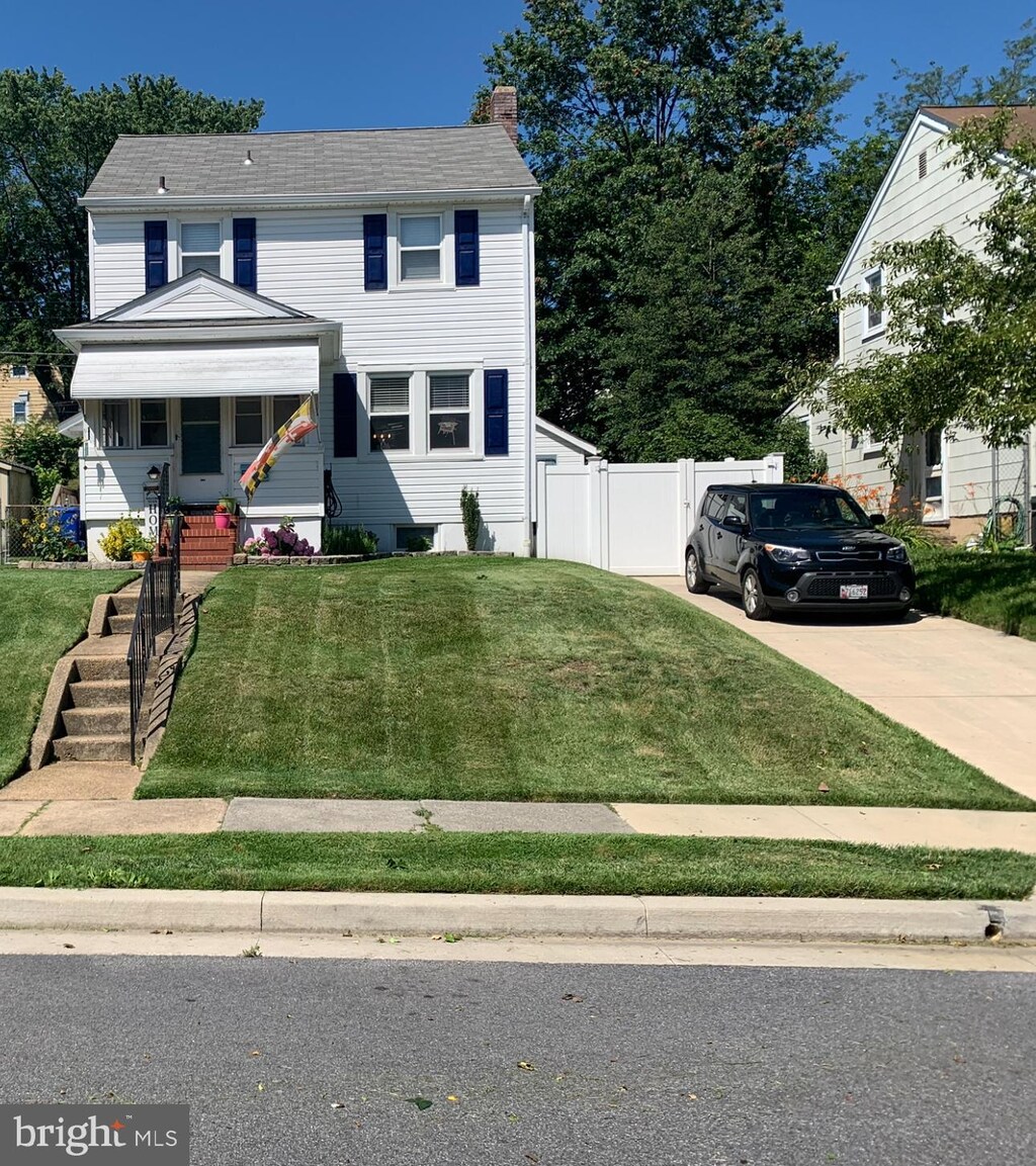 5536 Ashbourne Rd, Halethorpe, MD 21227 - view of front facade with a chimney and concrete driveway