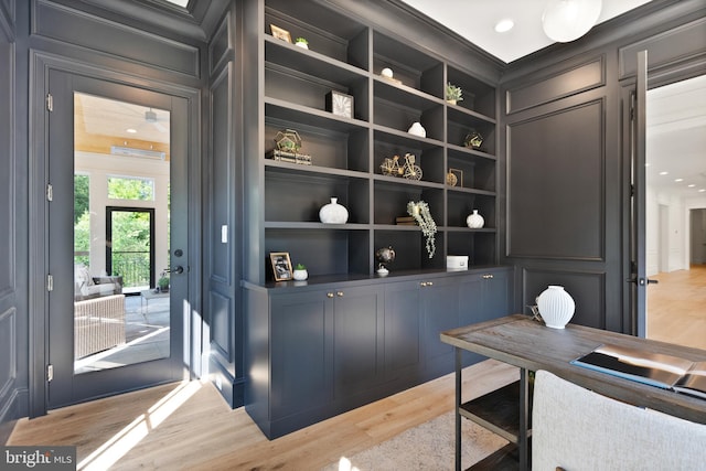 6952 Duncraig Ct, Mclean, VA 22101 - office space with a decorative wall, built in shelves, light wood-style floors, and crown molding