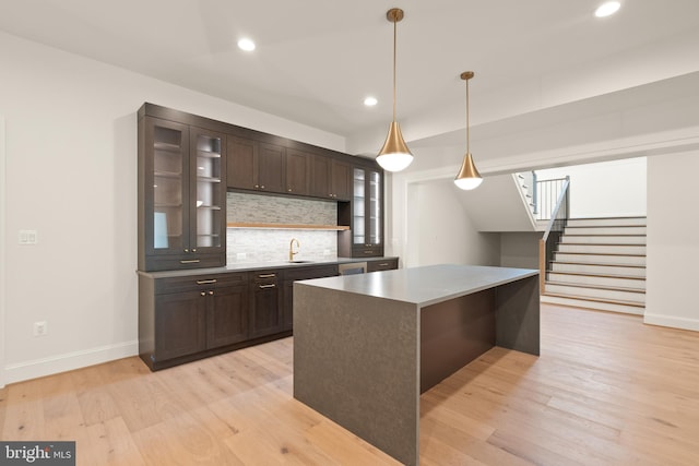 6952 Duncraig Ct, Mclean, VA 22101 - kitchen featuring dark brown cabinets, a sink, tasteful backsplash, recessed lighting, and light wood finished floors
