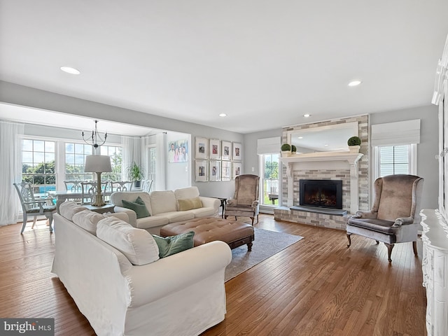 13225 Manor S, Mount Airy, MD 21771 - living area featuring healthy amount of natural light, wood finished floors, a brick fireplace, and recessed lighting