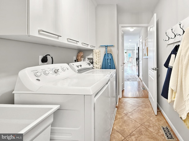 13225 Manor S, Mount Airy, MD 21771 - washroom featuring cabinet space, washer and clothes dryer, light tile patterned flooring, and baseboards