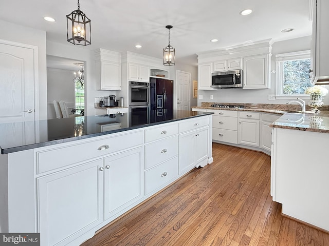 13225 Manor S, Mount Airy, MD 21771 - kitchen with stainless steel appliances, a center island, white cabinets, light wood-style floors, and a sink
